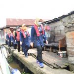 Susuri Sungai Musi, Feby Deru Bagikan Paket Sembako